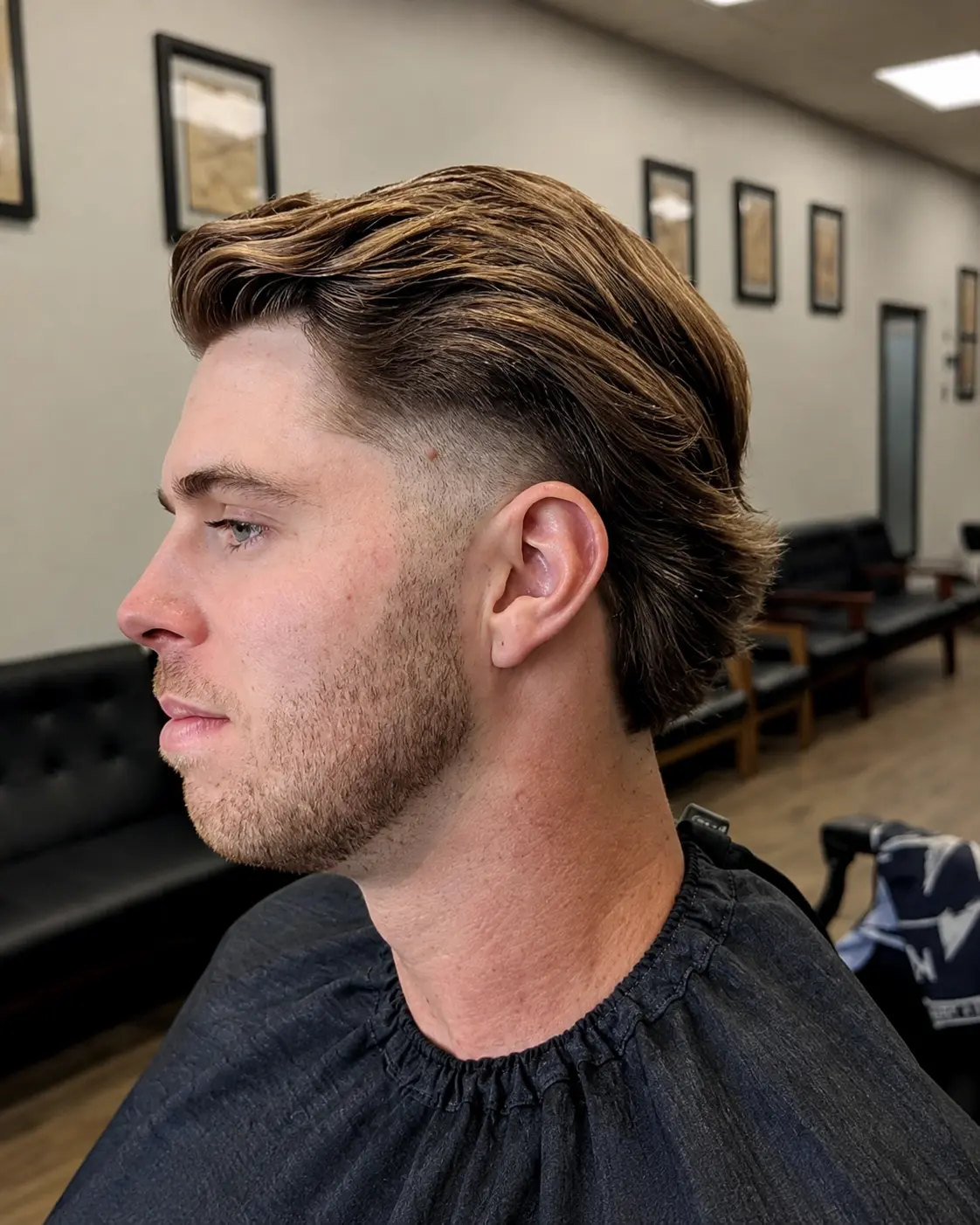 Mid fade with longer, flowing layers swept back over the top